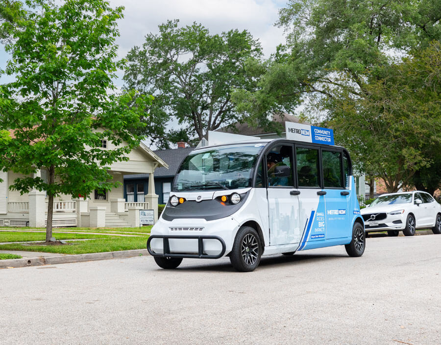 A Community Connector vehicle rolling down a residential area.